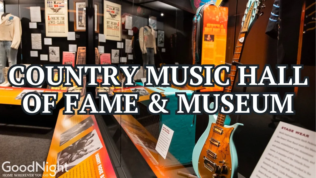 An interior shot of the Country Music Hall of Fame, showcasing exhibits with stage wear, guitars, and vintage posters. The space is filled with historical displays and interactive elements, evoking the city's vibrant music culture.