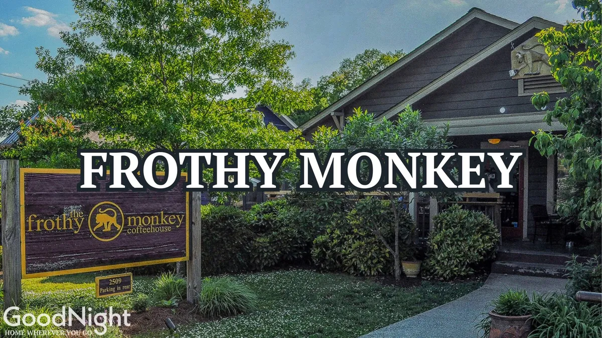 The image features the exterior of Frothy Monkey, a well-known Nashville coffeehouse, with its inviting signage, lush greenery, and cozy entrance. There are people enjoying coffee outdoors, contributing to a welcoming and relaxed atmosphere.