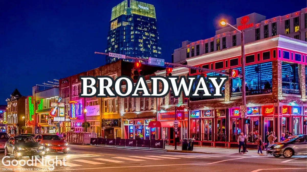 A bustling Nashville street illuminated by vibrant neon signs, filled with a crowd of people enjoying nightlife, dining at restaurants, shopping, and experiencing live music. The colorful buildings and energy of the scene evoke Nashville's legendary Broadway atmosphere.